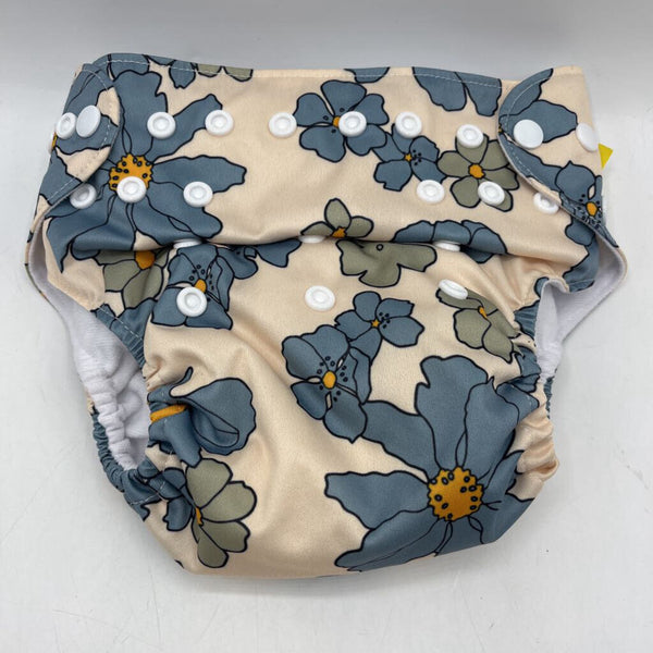 Size O/S: Nora's Nursery Creme/Blue Floral Adjustable Snap Diaper